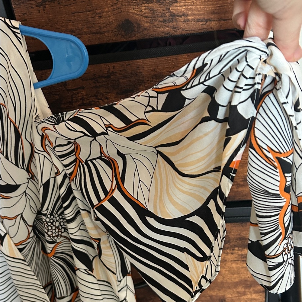 Adelyn Rae Black and Orange Patterned Romper - Picture 6 of 9